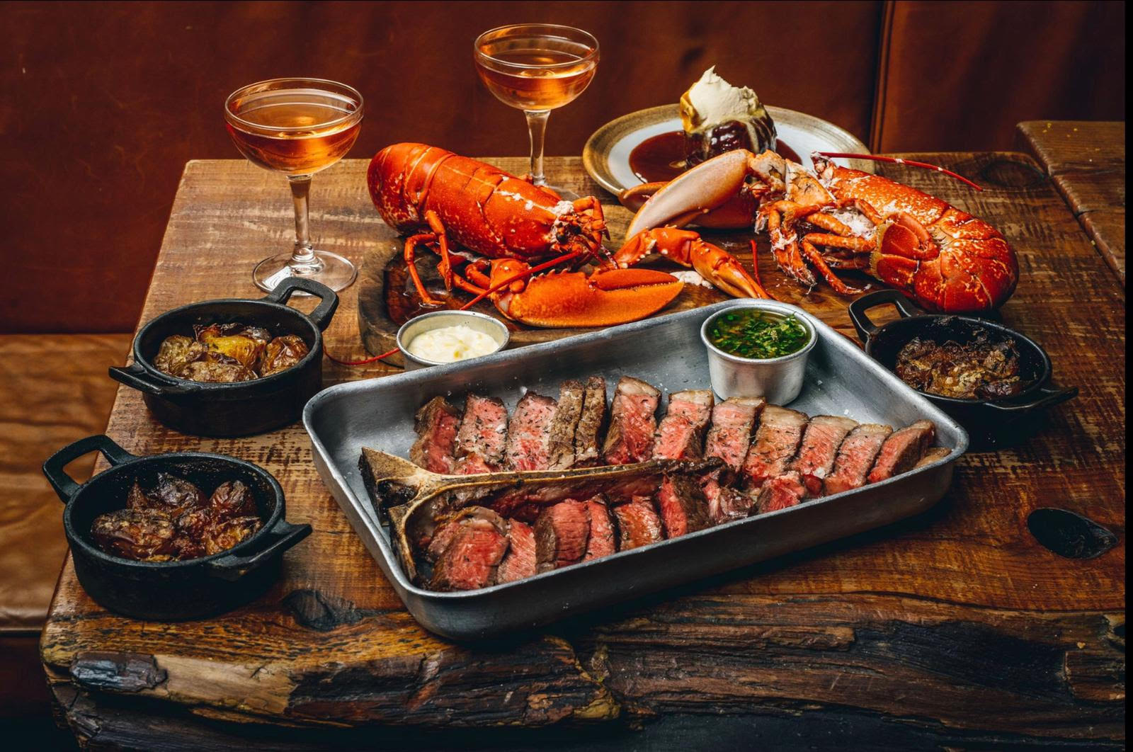 Mac & Wild feast of tomahawk steak, lobster, sides and whisky cocktails