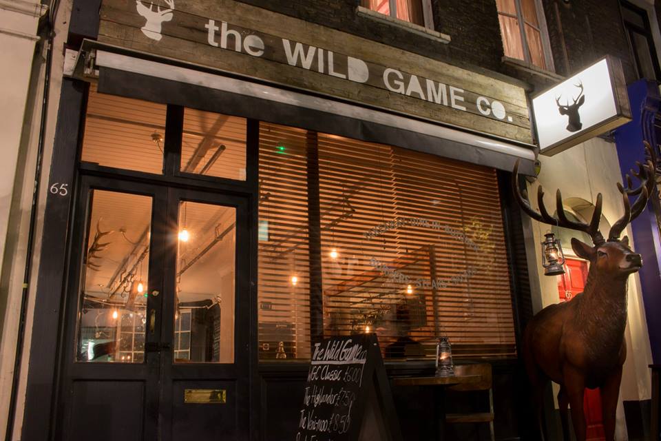 The Wild Game Co. storefront at night
